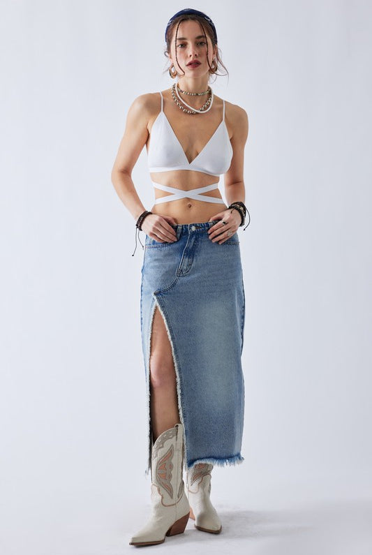 Model wearing a denim maxi skirt with boots for a boho street style look