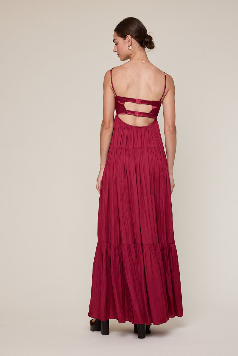 Back view of burgundy corset dress with cutout open back and straps
