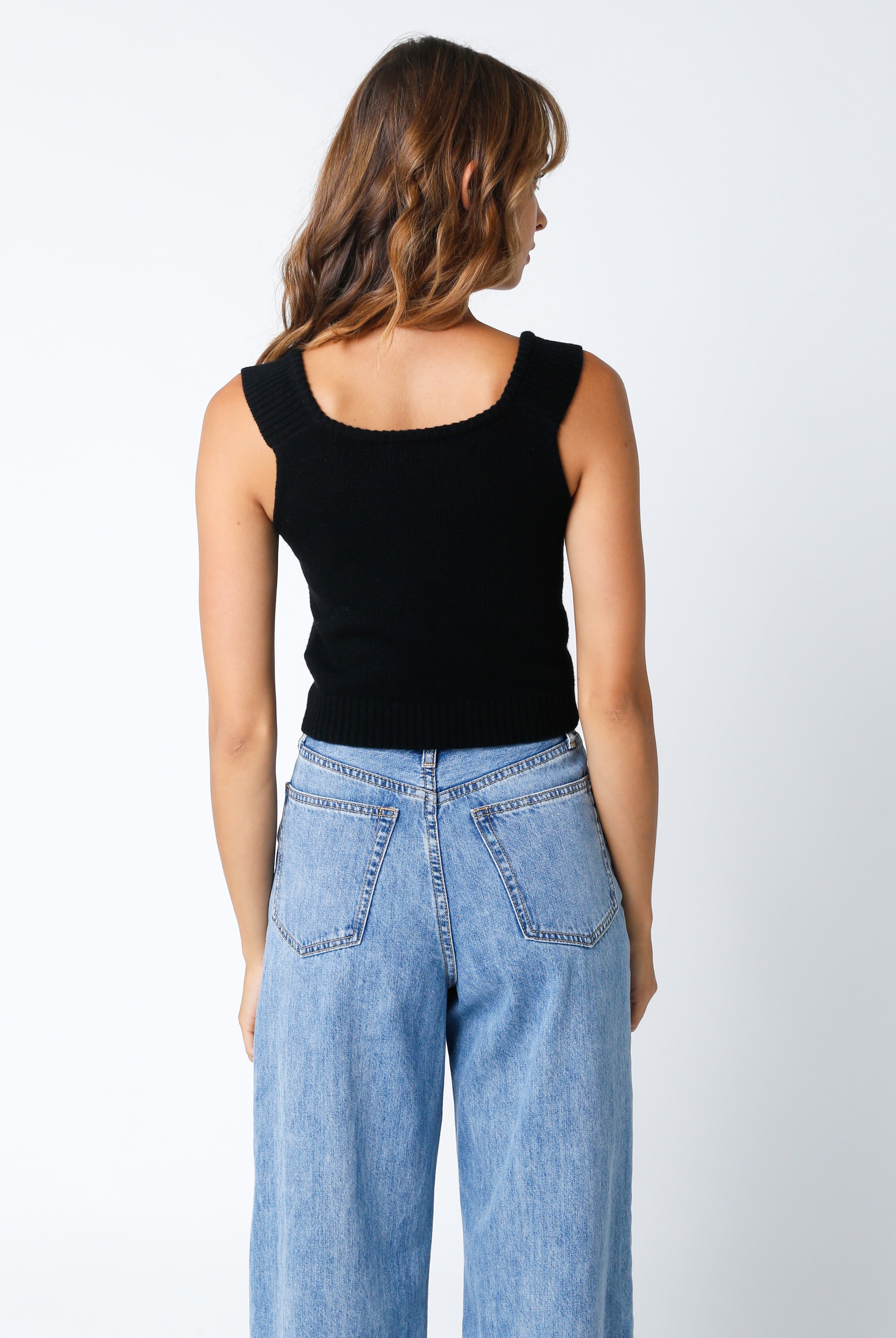 Back view feminine black sweater corset top with sweetheart neckline for a fitted silhouette.
