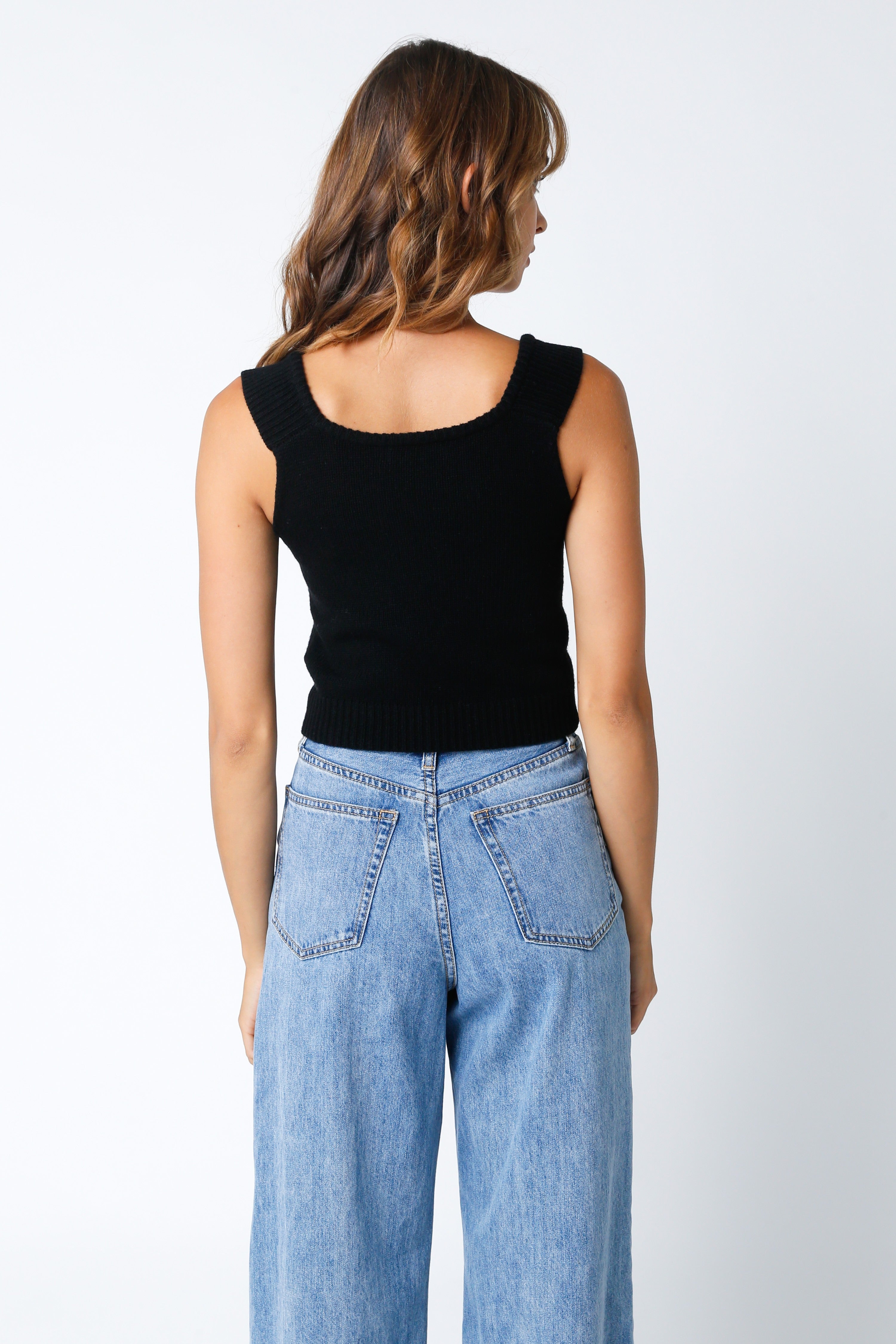 Back view feminine black sweater corset top with sweetheart neckline for a fitted silhouette.