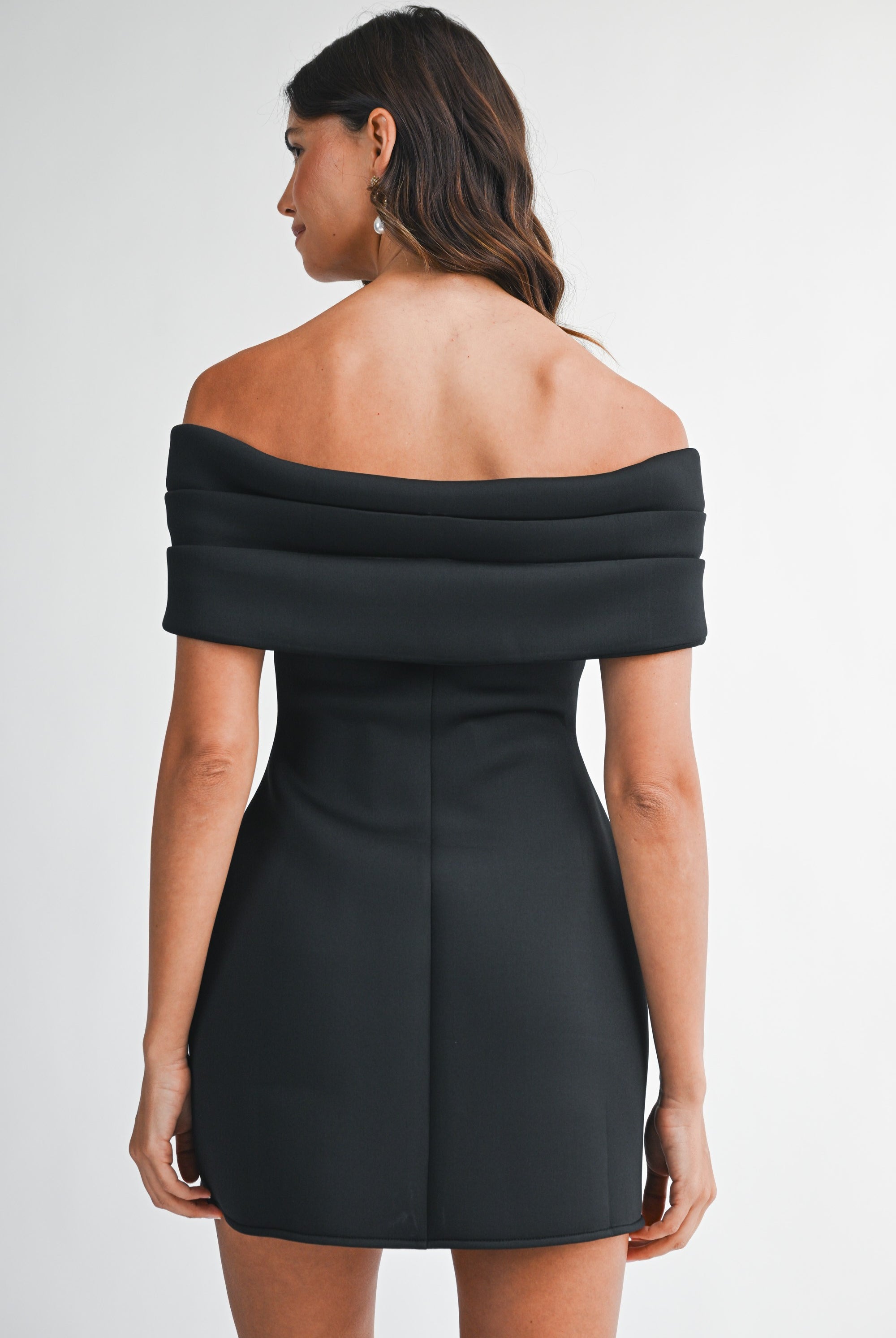 Back view of the black dress highlighting the off-the-shoulder neckline