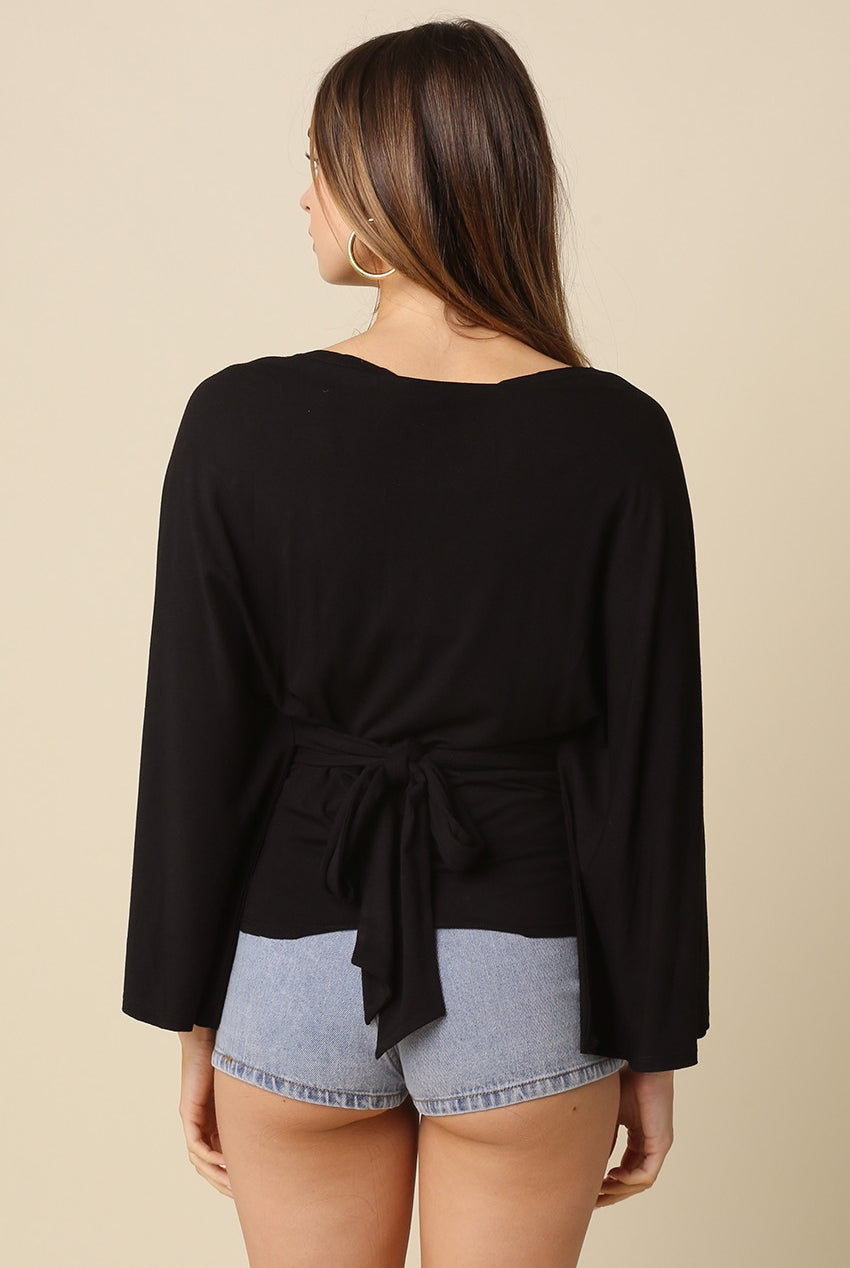 Black dolman sleeve top featuring adjustable back tie waist