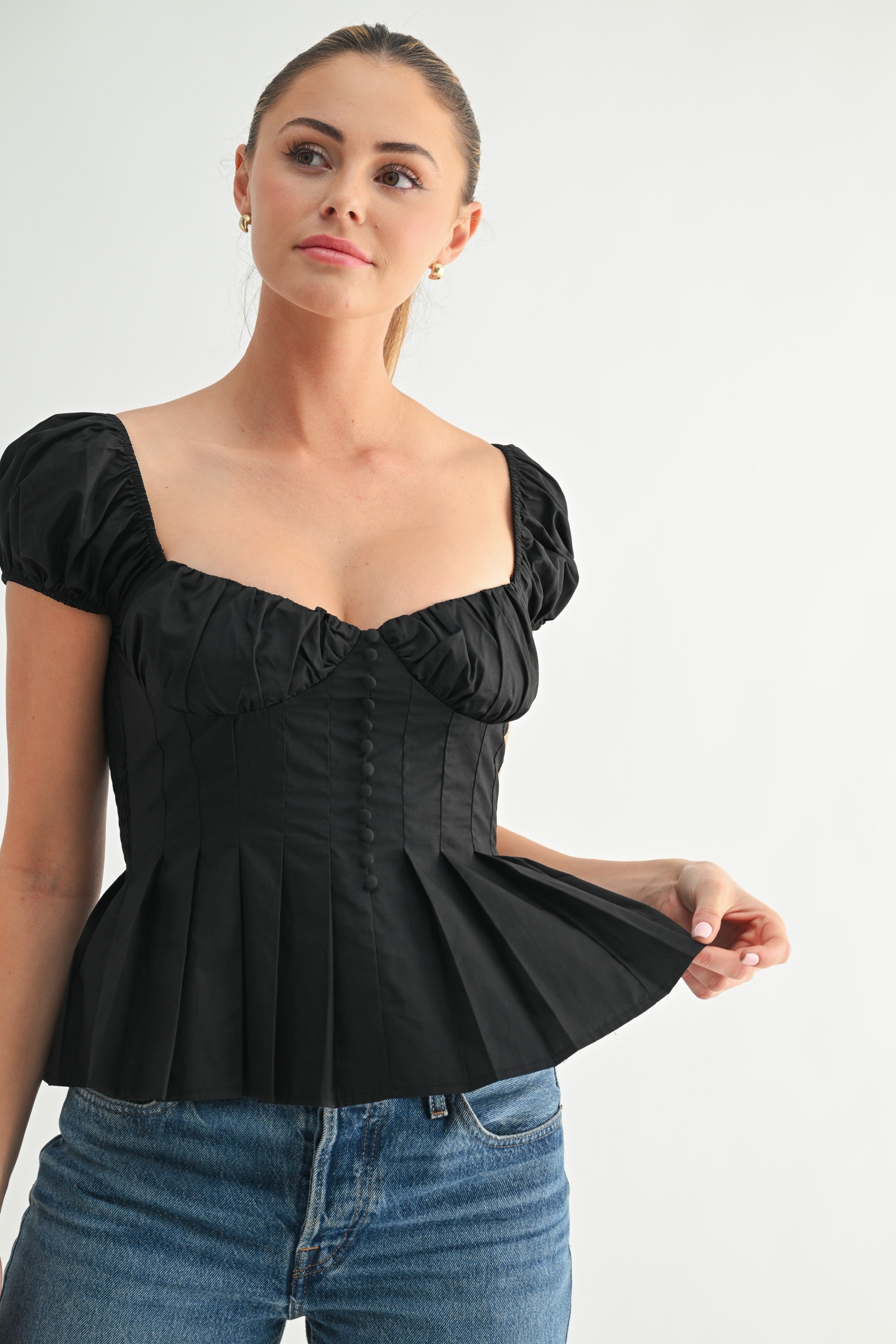 Romantic black corset top styled with jeans