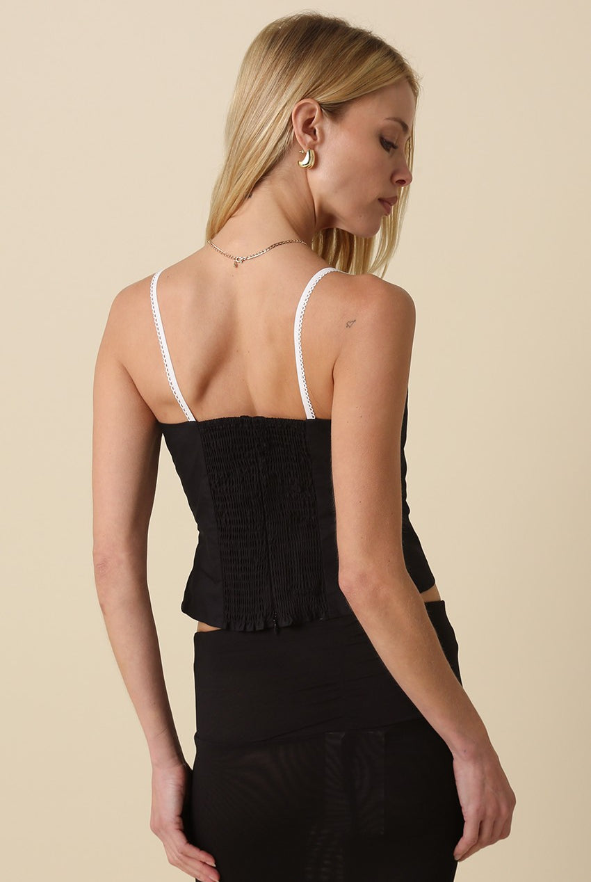 The back of the Devyn black top highlighting the stretchy smocked panel and hidden zipper closure