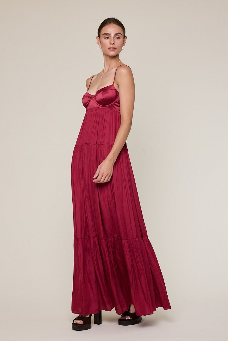 Side view of burgundy satin maxi dress with corset bodice styled for prom