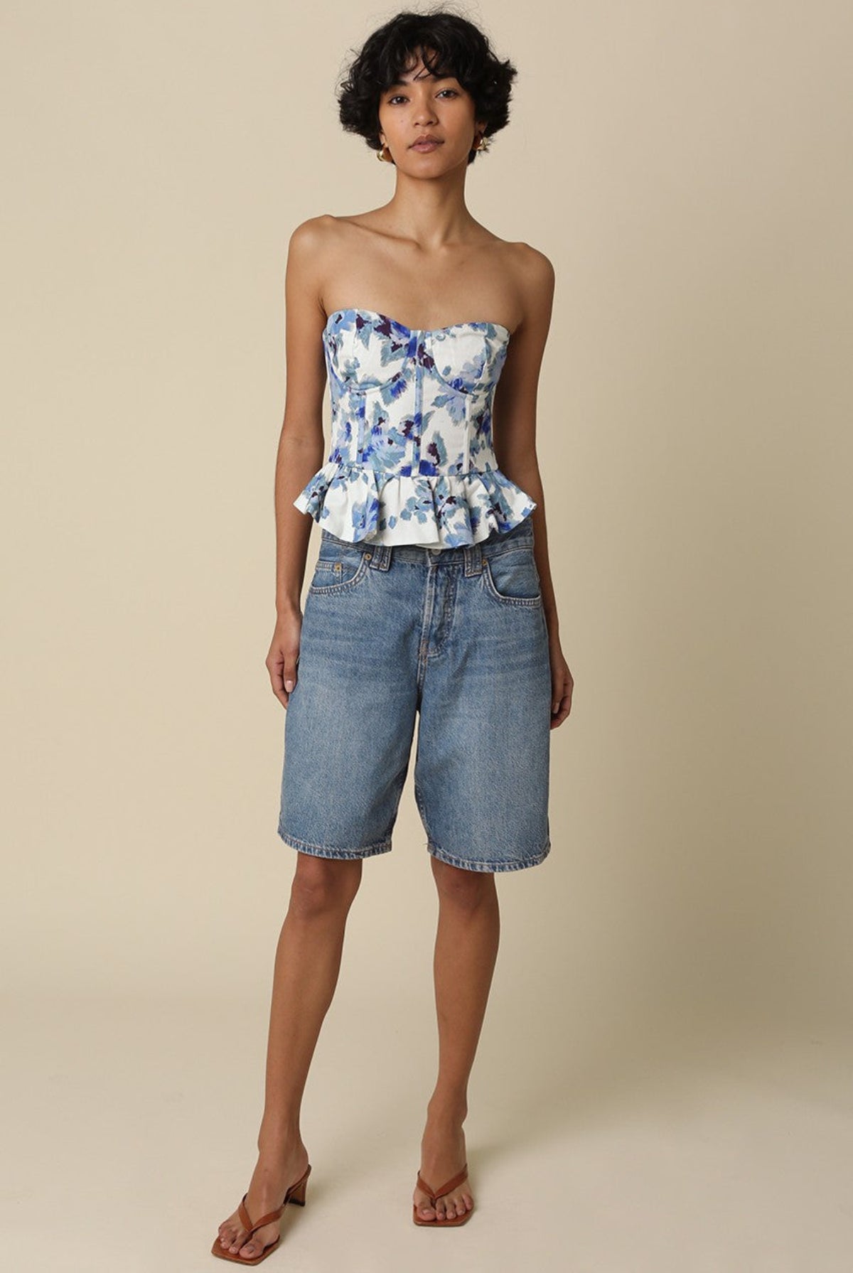 Full length front view of the Dani white and blue floral strapless corset top with peplum ruffle hem