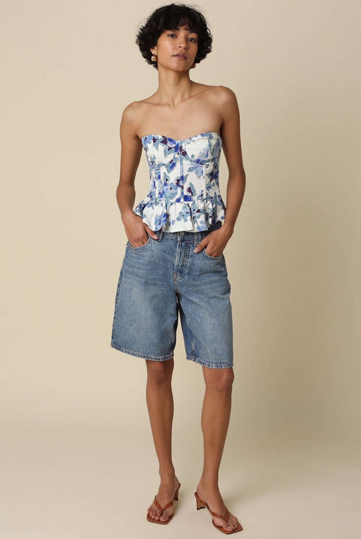 Dani floral corset top styled with long denim shorts and brown heels