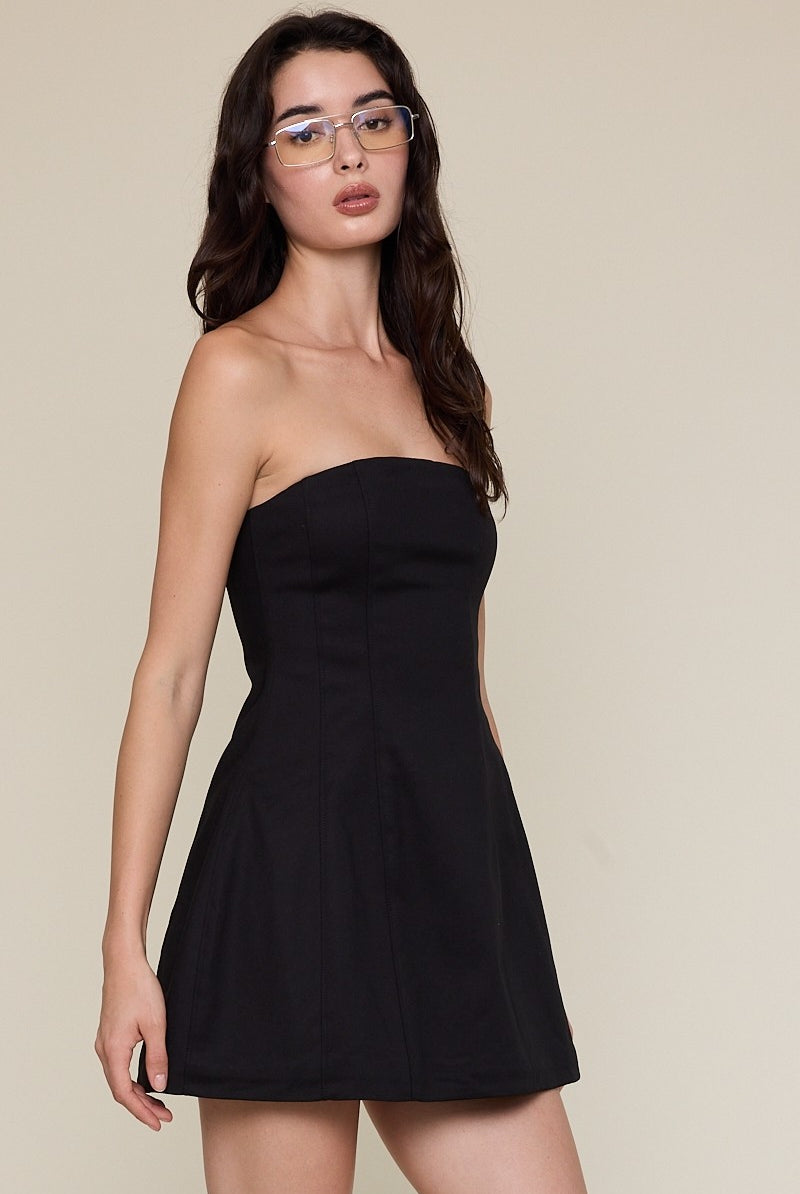 Side view of a black strapless flared dress showing the tailored A-line silhouette