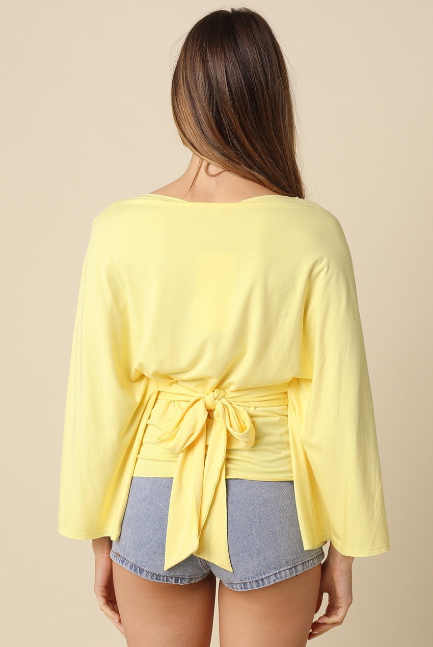 Yellow dolman sleeve top featuring adjustable back tie waist
