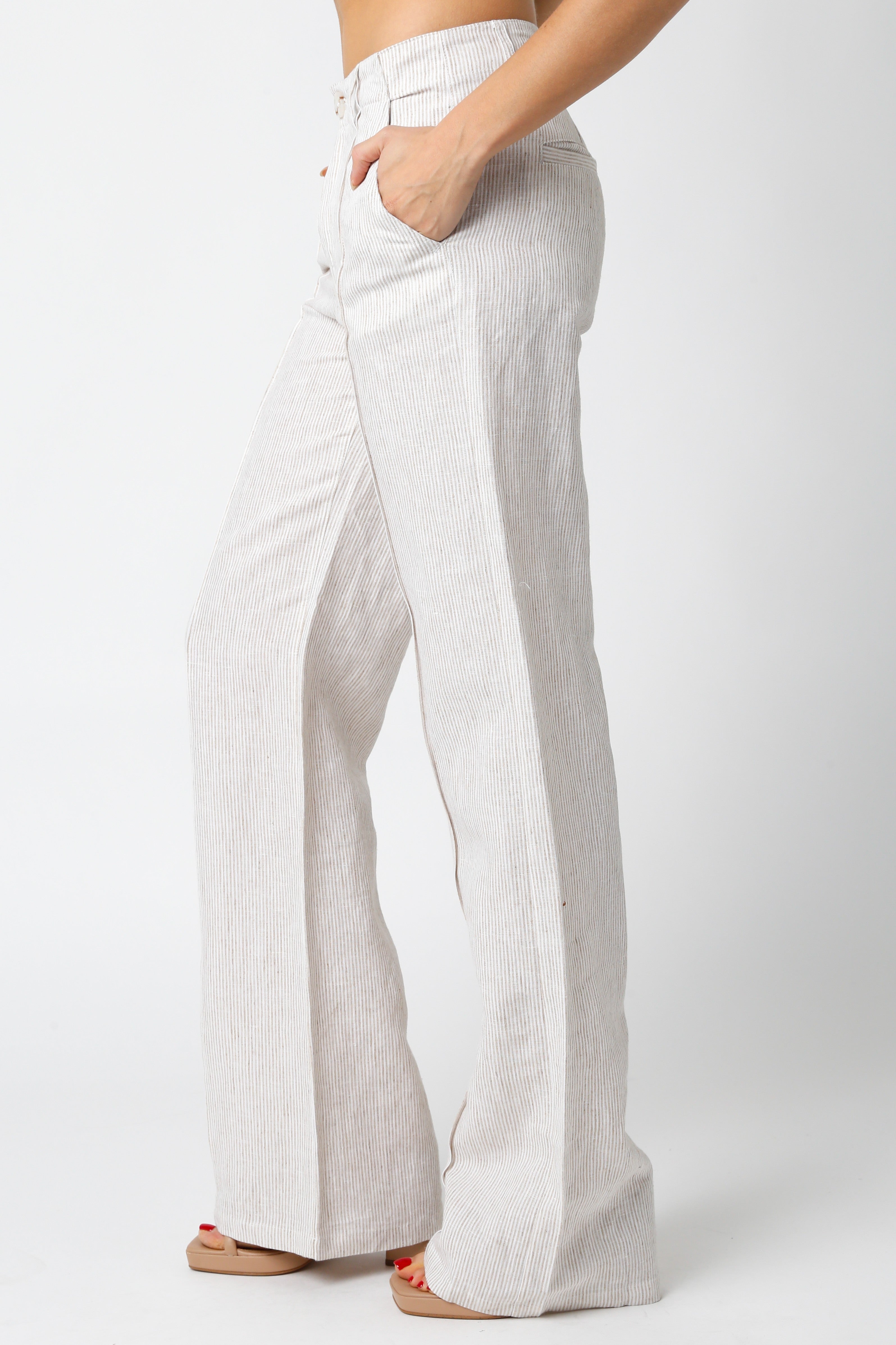 Coastal style khaki pinstripe linen trousers for summer vacation outfit.