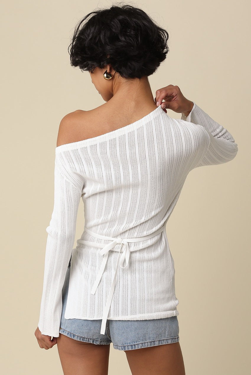 Back view of the asymmetrical off-the-shoulder neckline on the white top