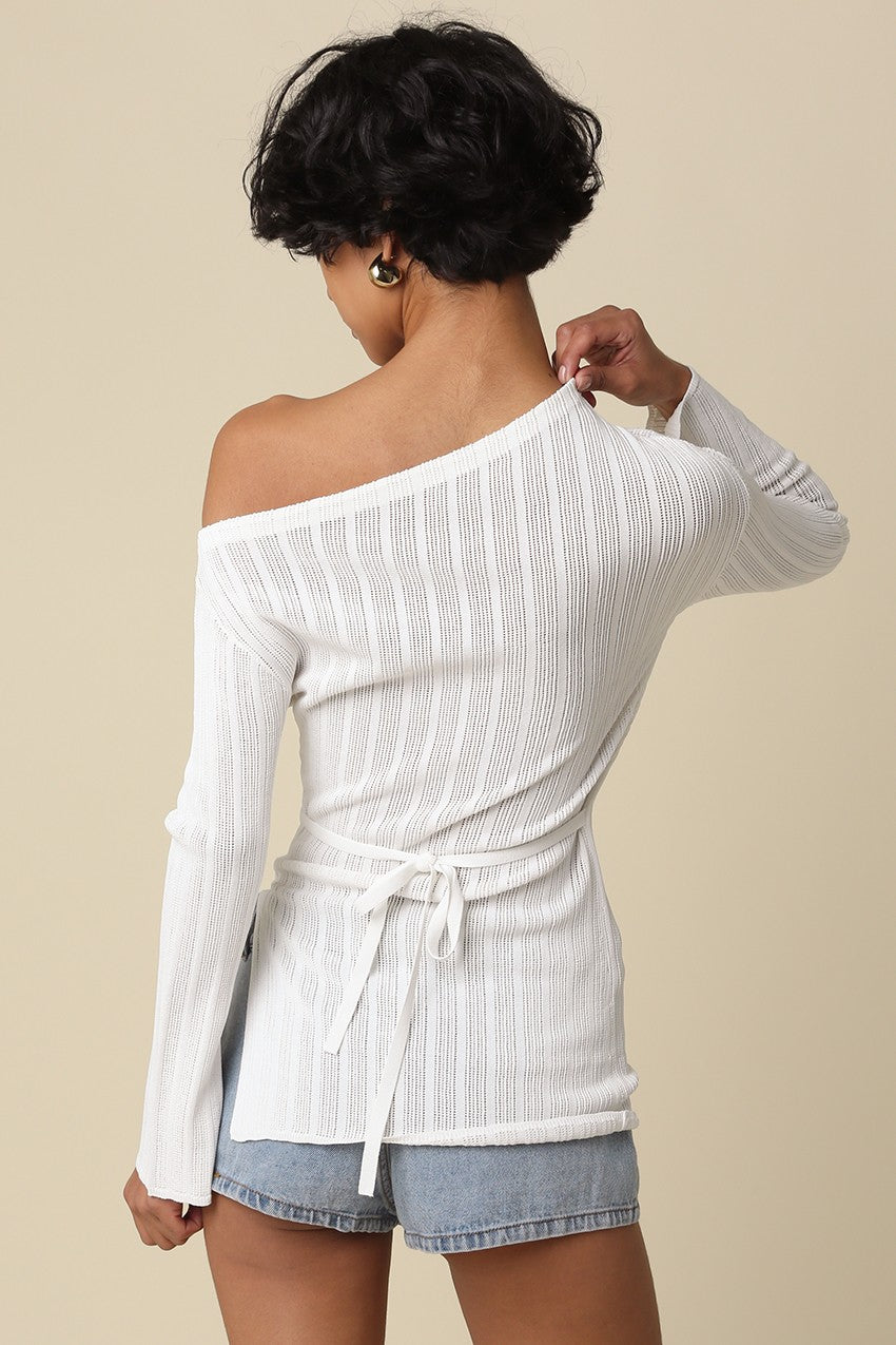 Back view of the asymmetrical off-the-shoulder neckline on the white top