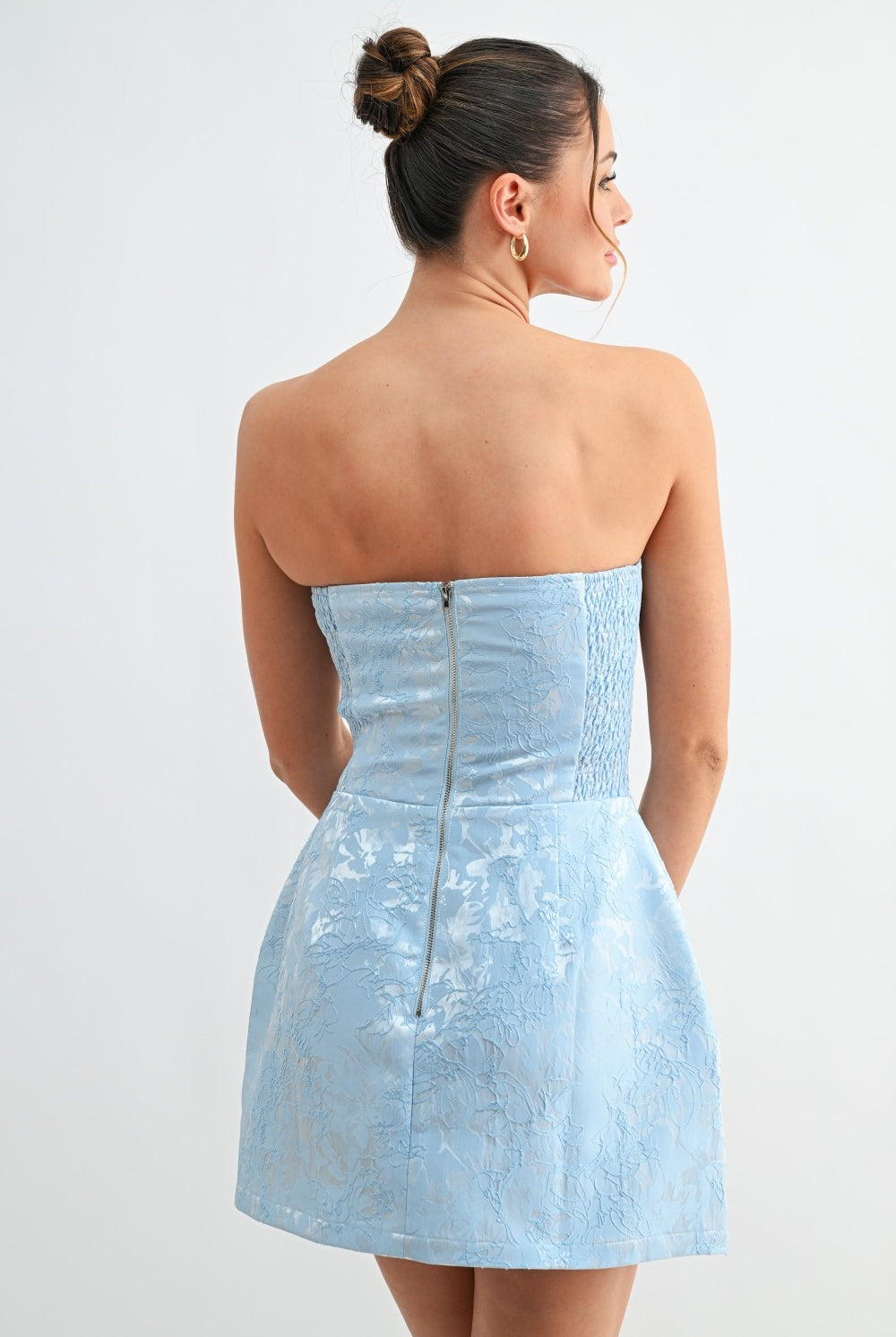Back view of blue strapless dress showing zipper closure