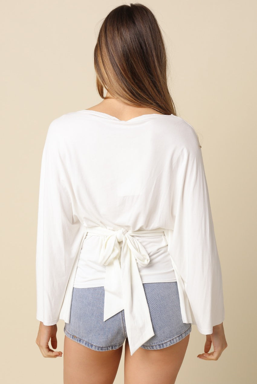 White dolman sleeve top featuring adjustable back tie waist