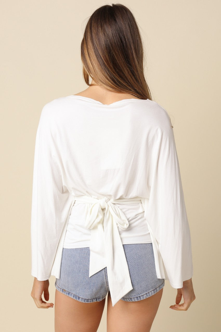 White dolman sleeve top featuring adjustable back tie waist