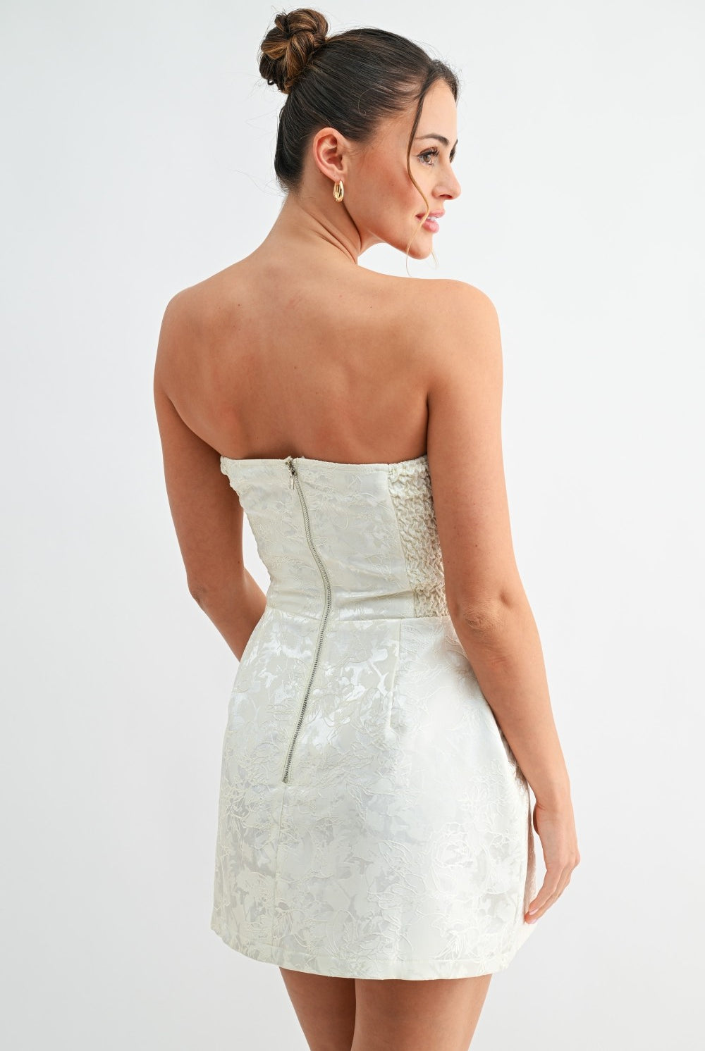 Back view of white strapless dress showing zipper closure