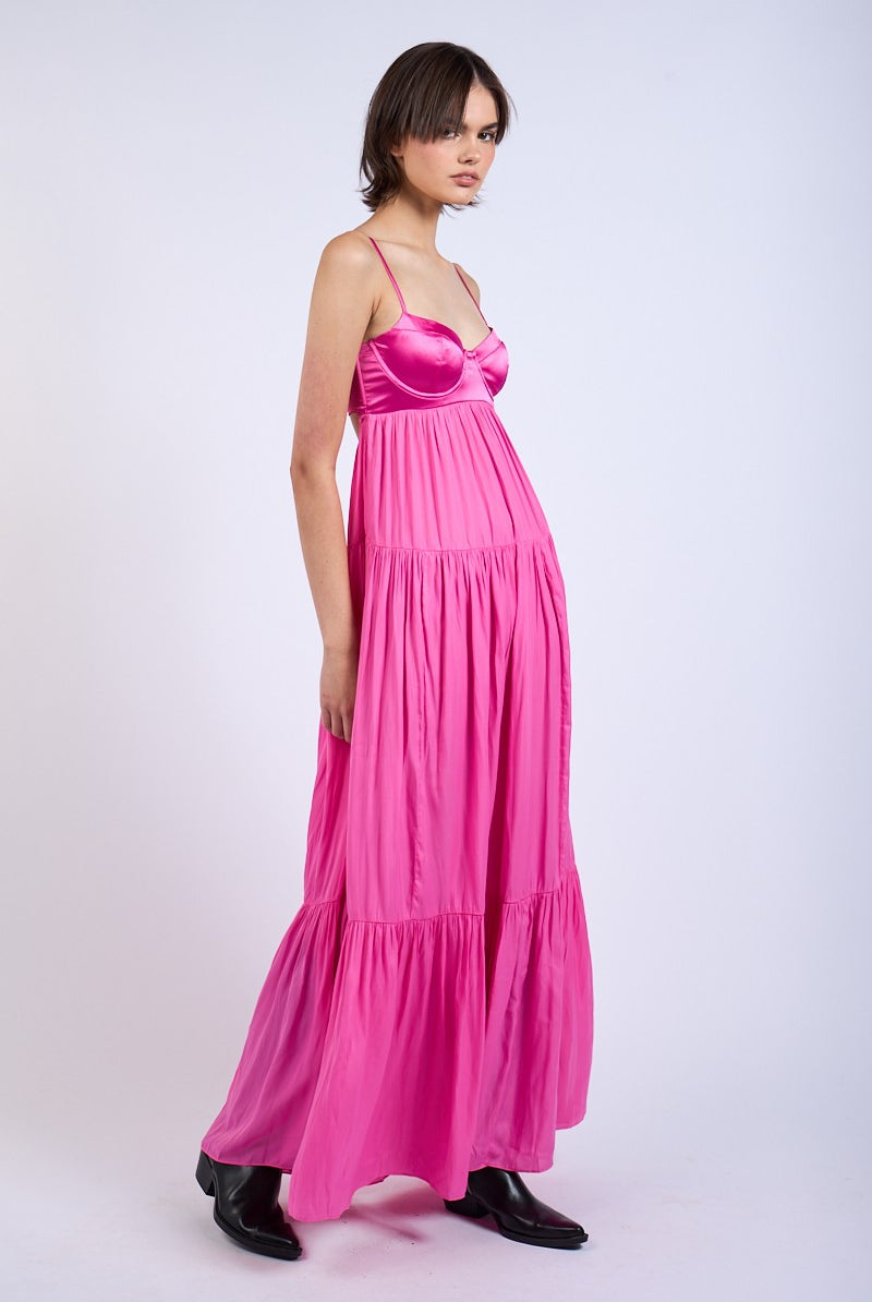 Side view of pink satin maxi dress showing structured corset bodice.