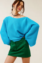 Oversized turquoise ribbed knit sweater with drop shoulders and a cropped fit.