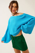 Vibrant turquoise boat neck sweater, perfect for transition weather outfits