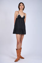 Styled for date night the Annie Black Babydoll Dress showing the ribbon lace babydoll mini dress