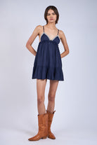 The Annie Navy Babydoll Dress styled with boots for date night.