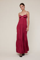 Flowy burgundy tiered maxi dress for formal evening celebrations.