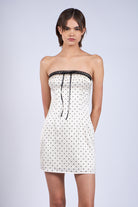 hort ivory polka dot bodycon dress styled with strappy heels for a night out