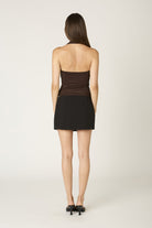 Back view of the Agathe brown halter top highlighting the sleek open-back design