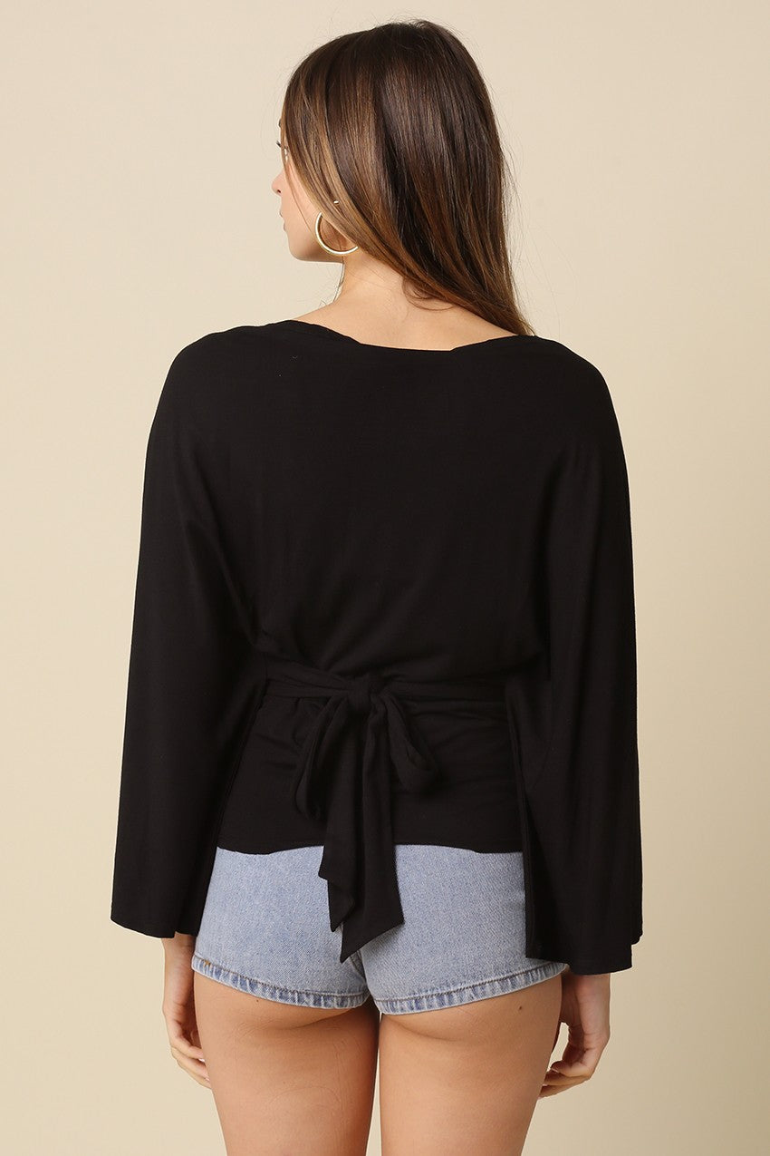 Black dolman sleeve top featuring adjustable back tie waist