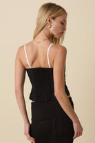 The back of the Devyn black top highlighting the stretchy smocked panel and hidden zipper closure