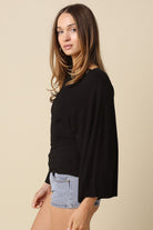 Black dolman sleeve knit top with wide sleeves