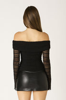 Back view of the lace top with the off-the-shoulder neckline and sheer lace sleeves