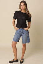 Women's breathable iblack linen blouse with puff sleeves and button front closure.