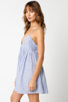 Close-up of premium blue striped linen fabric on a summer babydoll mini dress.