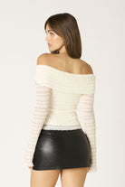 Side shot of the ivory floral lace fabric showing the intricate lace