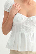 Romantic white corset top styled with khakis