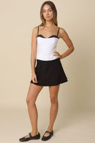 A chic night-out look featuring the Devyn white contrast corset top with a smocked back