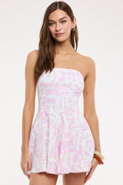 Model wearing the Dana pink and white strapless romper dress 