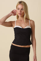Devyn Black Contrast Peekaboo Corset Top featuring white trim and a sweetheart neckline