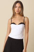 Devyn White Contrast Peekaboo Corset Top featuring black trim and a sweetheart neckline