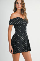 Side view of the Elyse mini dress showing the fitted bodice and pleated skirt