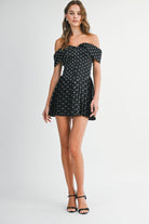 Model walking in the Elyse dress to show the movement and the pleated mini skirt