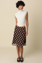 Model styling the Emily brown mesh midi skirt for a breezy, feminine look