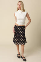 Full length shot of the Emily polka dot midi skirt in a breezy, A-line silhouette