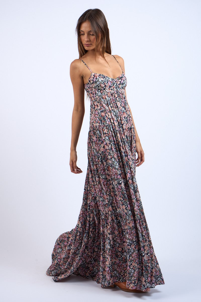 Side view of black floral maxi dress showing structured corset bodice.
