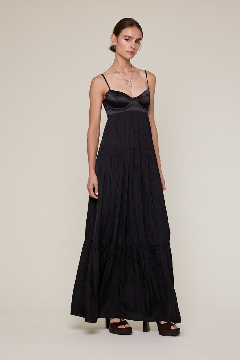 Side view of black satin maxi dress showing structured corset bodice