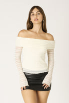 Long sleeve ivory lace top showing the fitted silhouette and sheer finish