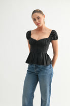 Black puff sleeve corset top with sweetheart neckline
