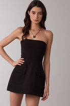 Model wearing Sky to Moon Lara black strapless mini dress with built-in shorts for graduation or sorority rush