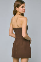 Back view of the chocolate brown Lara dress showing the stretchy smocked panel and hidden zipper closure.